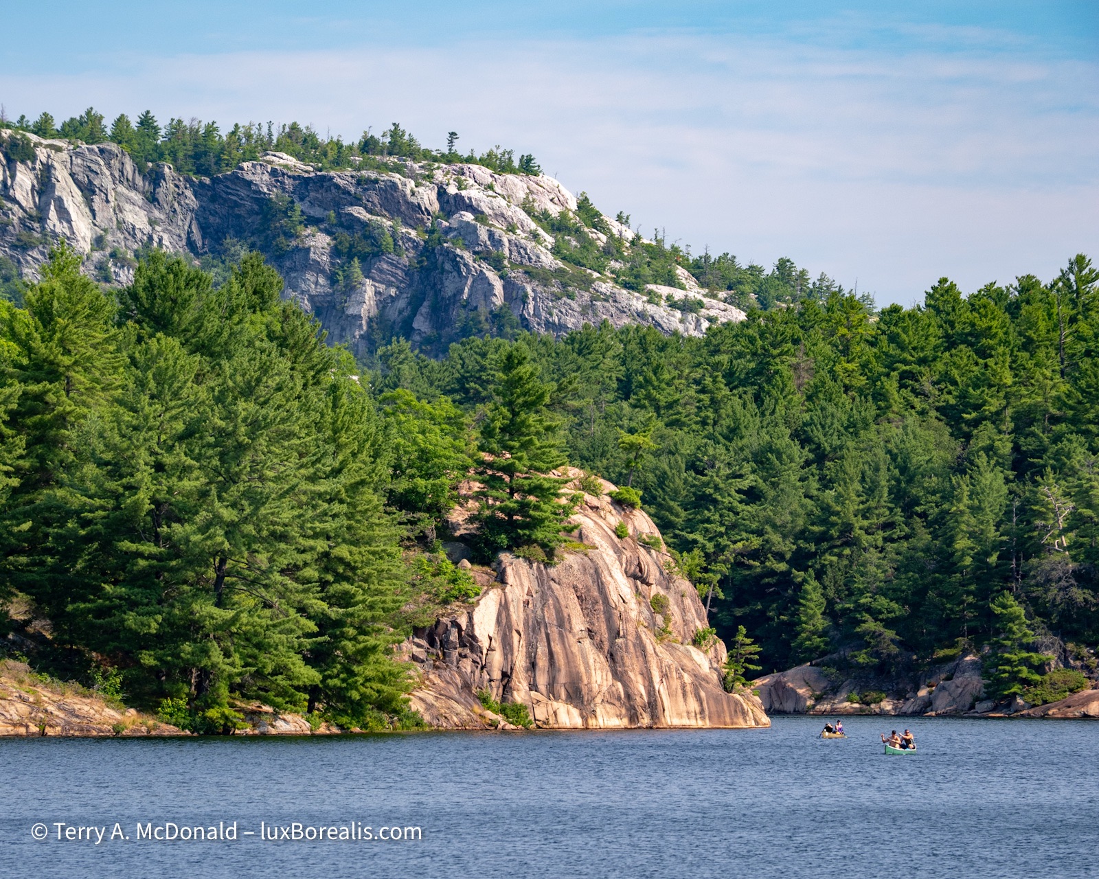 The view across George Lake, Killarney Provincial Park towards the pink granite monolith and the white quartzite La Cloche Range behind.