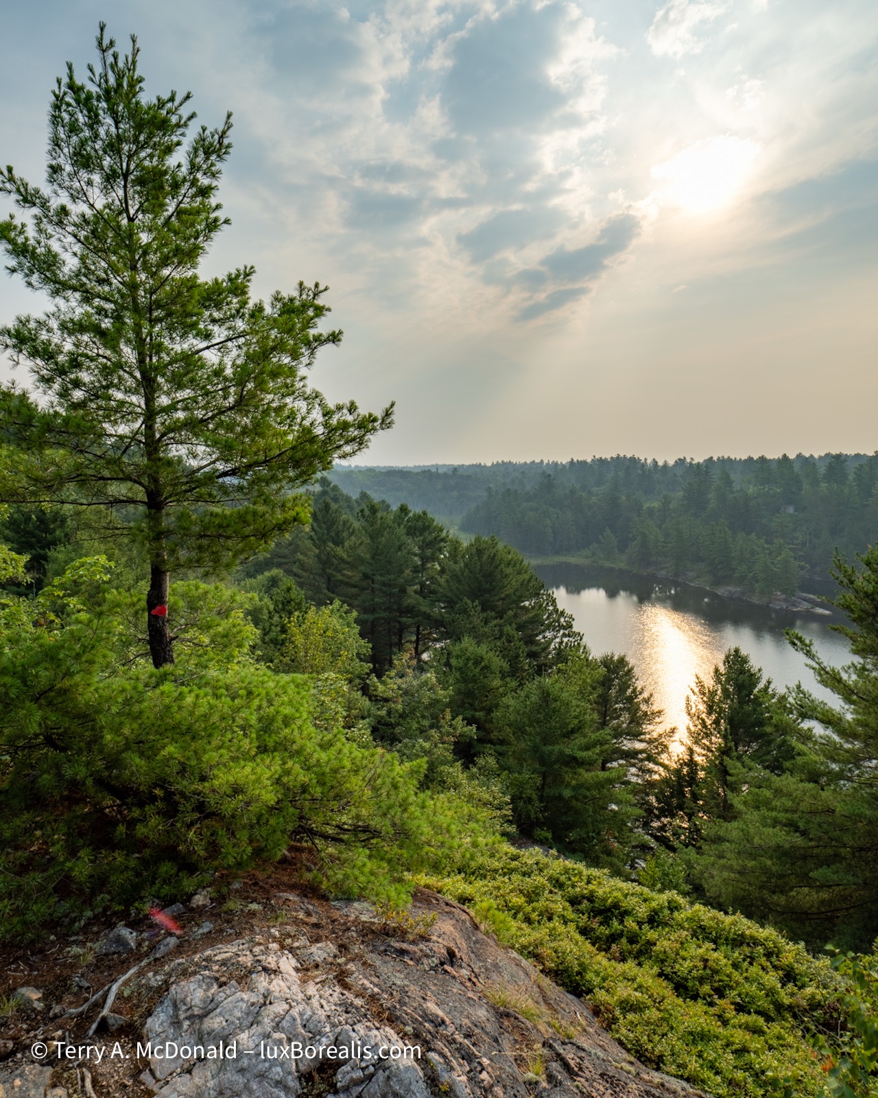The smokey haze from western wildfires turns the sky yellow in this view down Lake of the Woods.